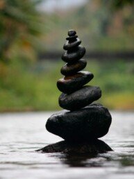 Black stackable stone decor at the body of water