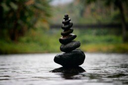 Black stackable stone decor at the body of water