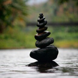 Black stackable stone decor at the body of water