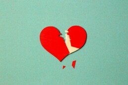 Broken heart against a blue background