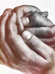 Men's hands hold the female palm on light, toned background. That could mean help, guardianship, protection, love, care etc.
