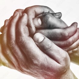 Men's hands hold the female palm on light, toned background. That could mean help, guardianship, protection, love, care etc.