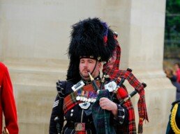 Traditional scottish bagpiper in ceremonial attire